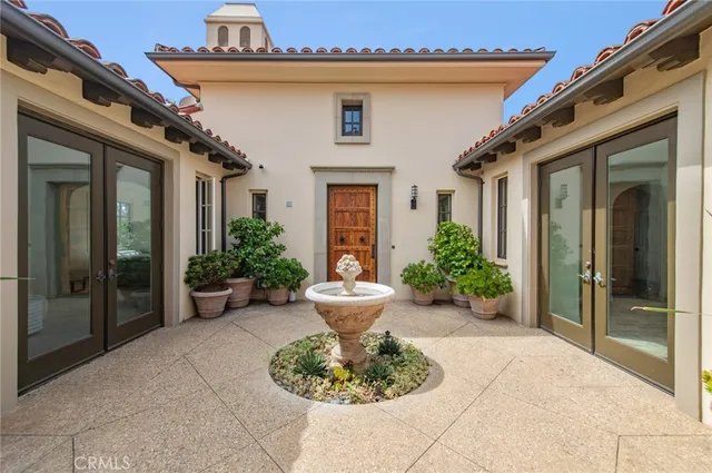 a view of a house with potted plants