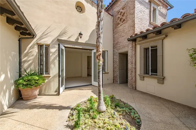 a house with potted plants in front of house