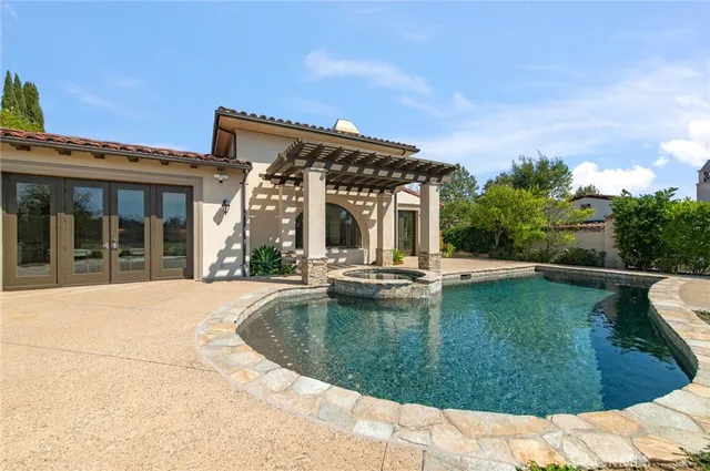 a view of a house with swimming pool and a porch