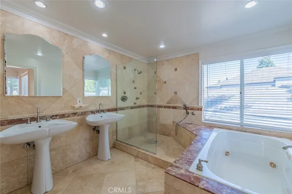 a bathroom with a tub sink and mirror