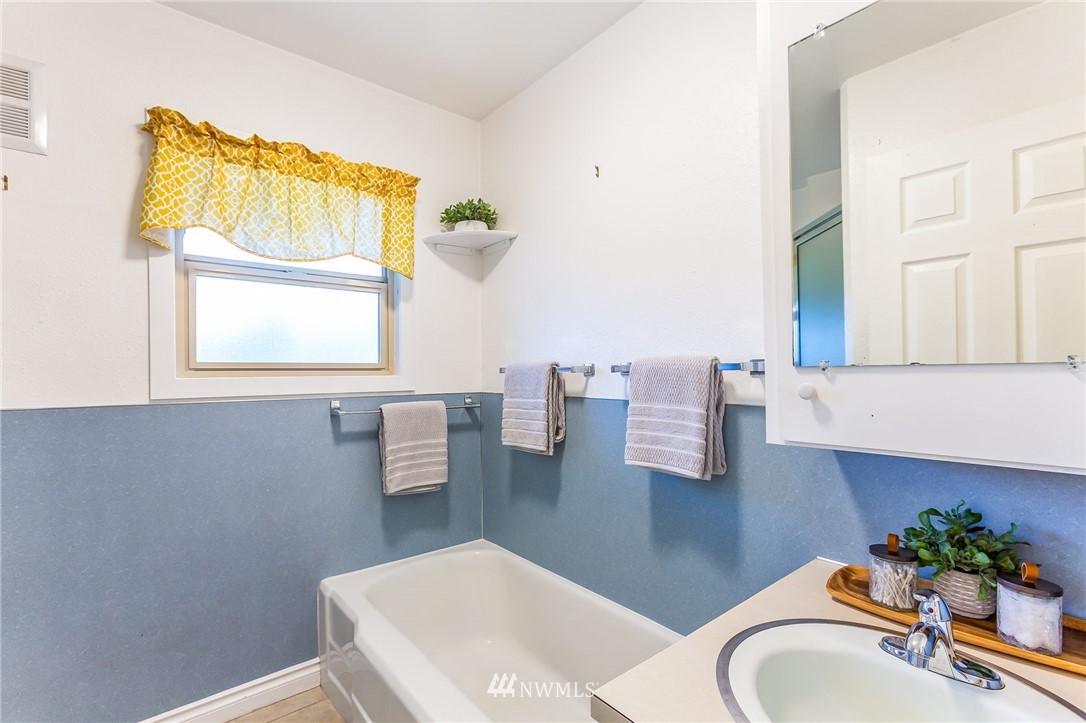 6009 Cady Road Everett, WA 98203 - Photo 21 of 40 a bathroom with a sink a mirror and a toilet
