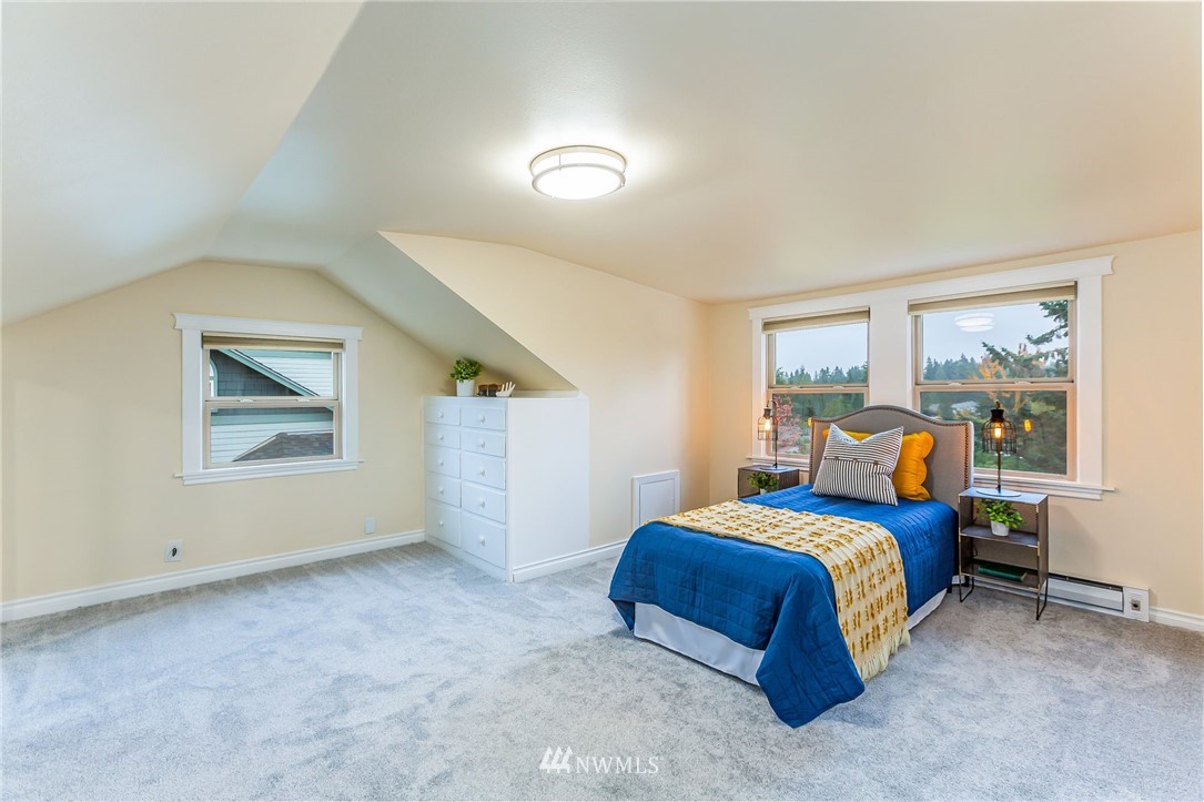 6009 Cady Road Everett, WA 98203 - Photo 26 of 40 a bedroom with a bed and wooden floor