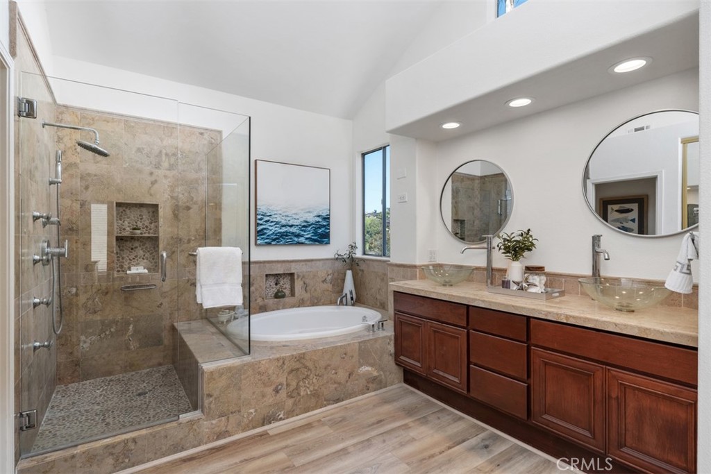 24882 Summerwind Dana Point, CA 92629 - Photo 11 of 31 a spacious bathroom with a granite countertop sink mirror and bathtub