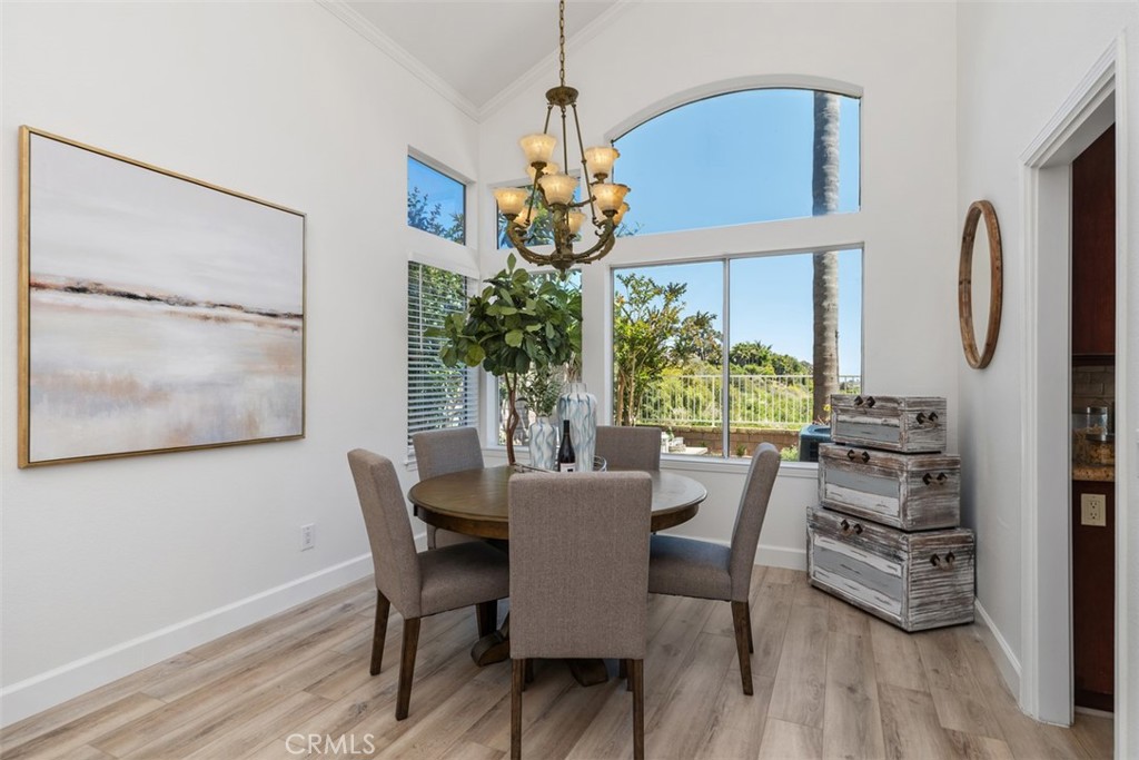 24882 Summerwind Dana Point, CA 92629 - Photo 18 of 31 a dining room with furniture potted plants and wooden floor