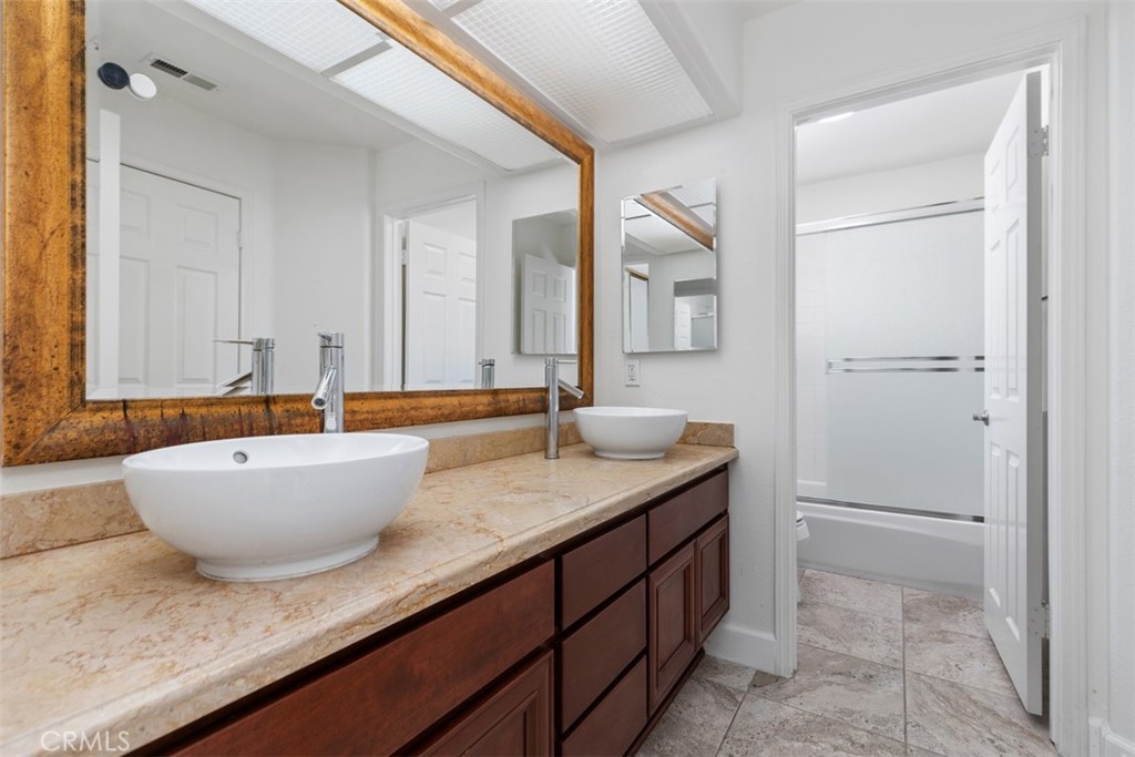 24882 Summerwind Dana Point, CA 92629 - Photo 20 of 31 a bathroom with a granite countertop sink and mirror