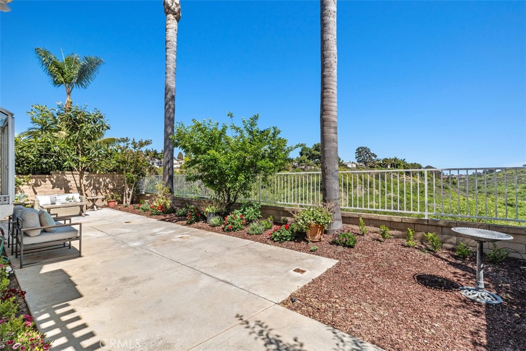 24882 Summerwind Dana Point, CA 92629 - Photo 25 of 31 a view of a garden with a bench in patio