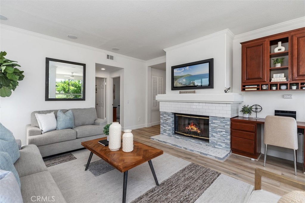 24882 Summerwind Dana Point, CA 92629 - Photo 6 of 31 a living room with furniture a flat screen tv and a fireplace