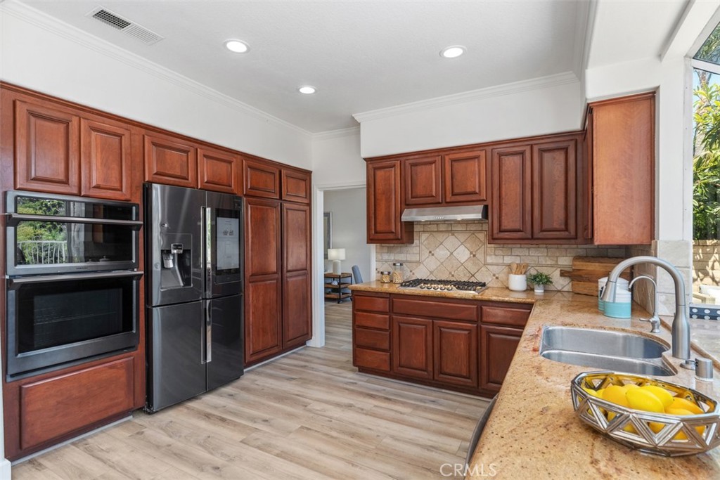 24882 Summerwind Dana Point, CA 92629 - Photo 7 of 31 a kitchen with stainless steel appliances granite countertop a refrigerator stove and sink
