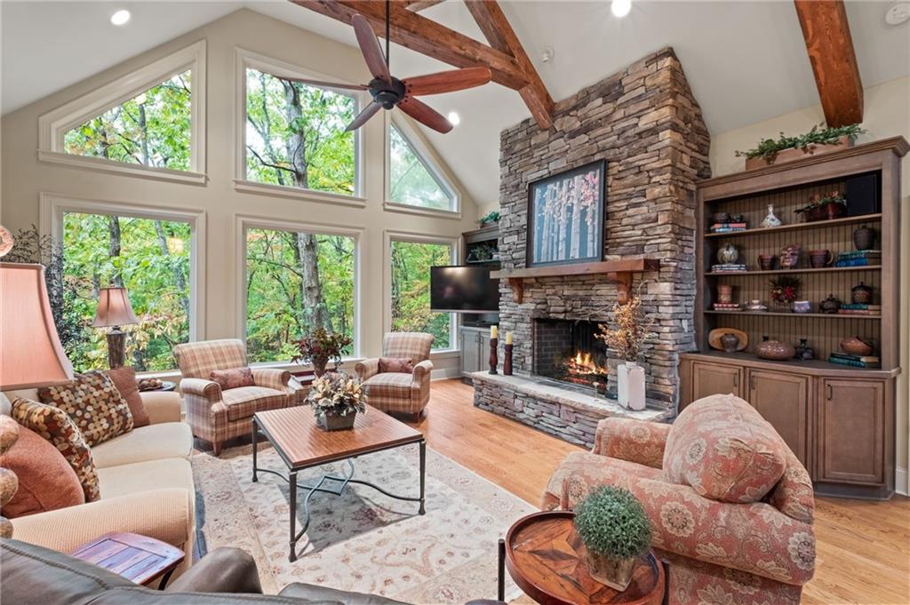 a living room with furniture fireplace and a large window