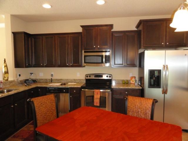 Lot 46 Grayling Way Inlet Beach Inlet Beach, FL 32461 - Photo 4 of 10 a kitchen with stainless steel appliances wooden cabinets and granite counter tops