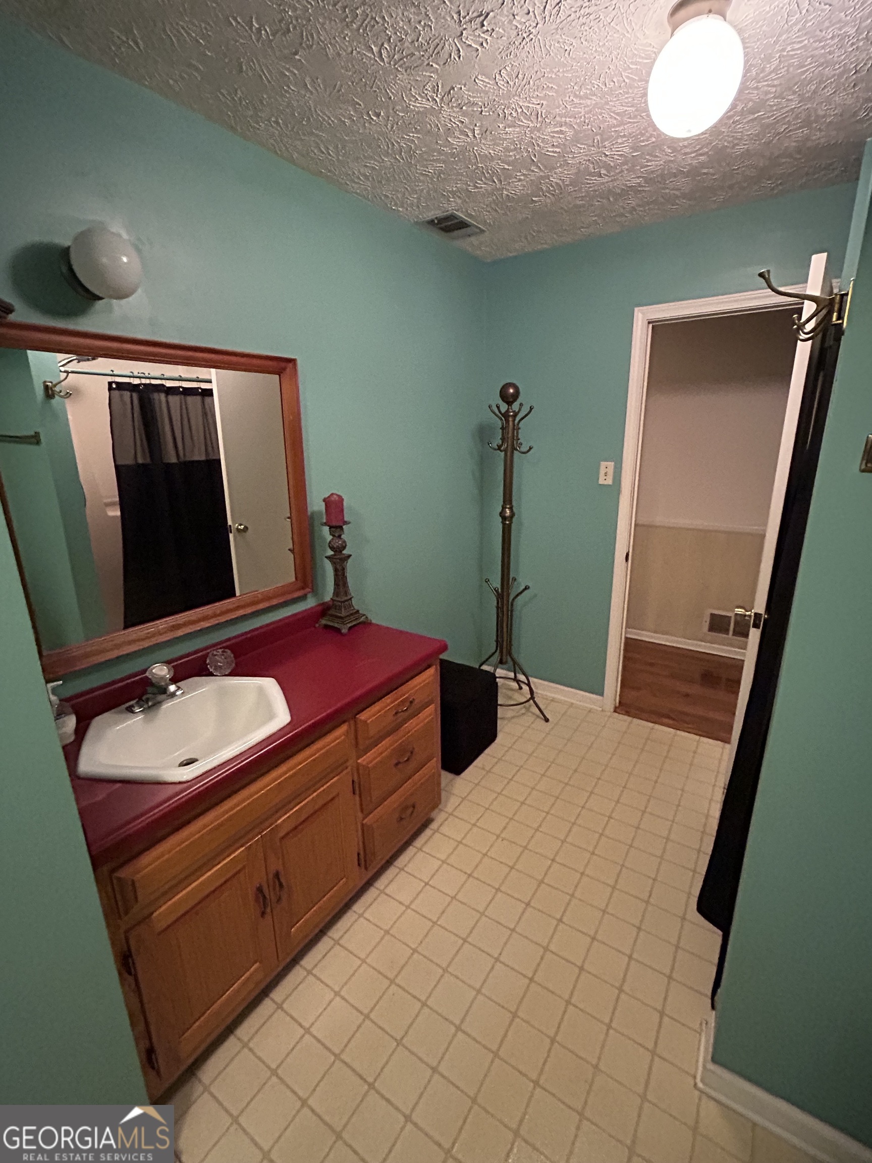1595 Timothy Road Athens, GA 30606 - Photo 9 of 22 a bedroom with a bed and a mirror on dresser