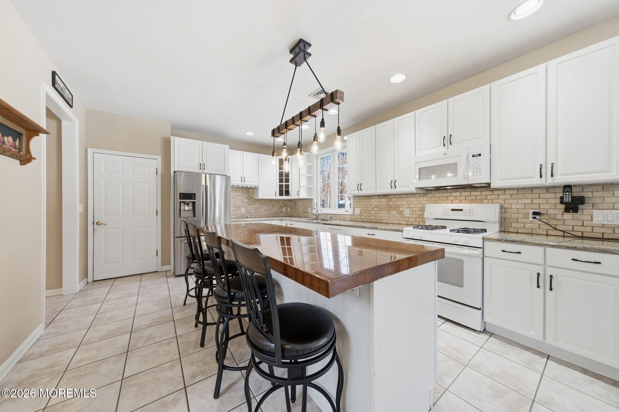 17 Amanda Lane Howell, NJ 07731 - Photo 13 of 35 a kitchen with stainless steel appliances granite countertop a sink a stove a refrigerator and cabinets