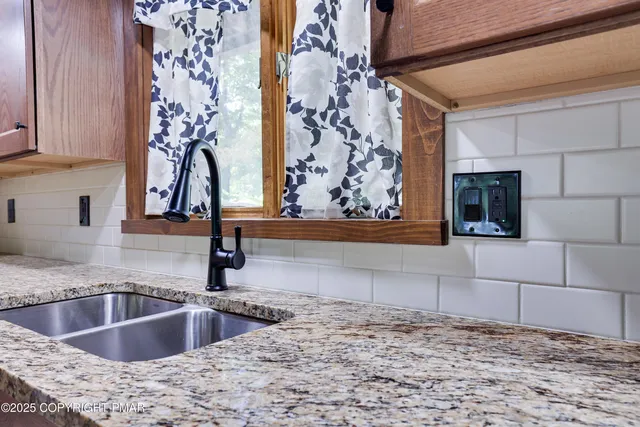 a view of a kitchen sink and a window