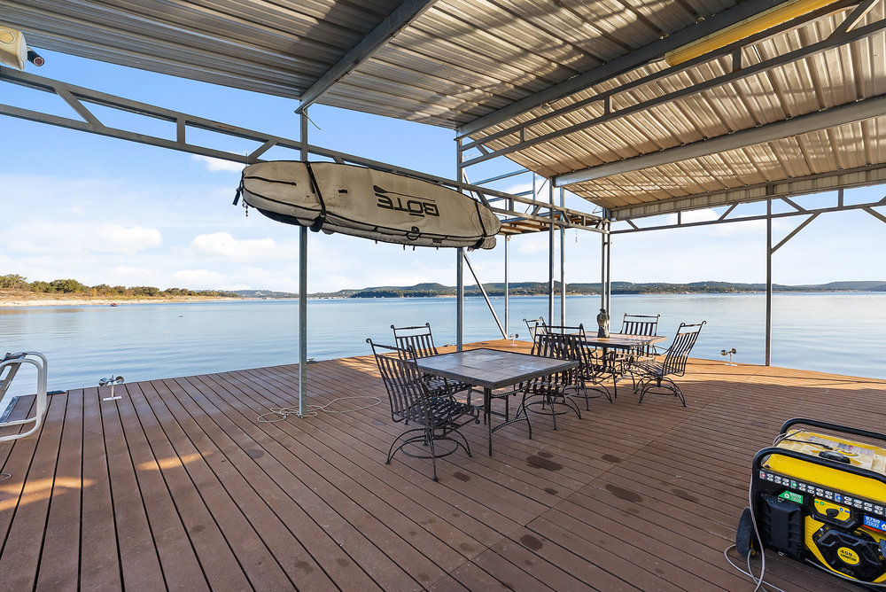 15210 Rainbow 1 Street Austin, TX 78734 - Photo 35 of 40 a view of a roof deck with table and chairs a barbeque with wooden floor