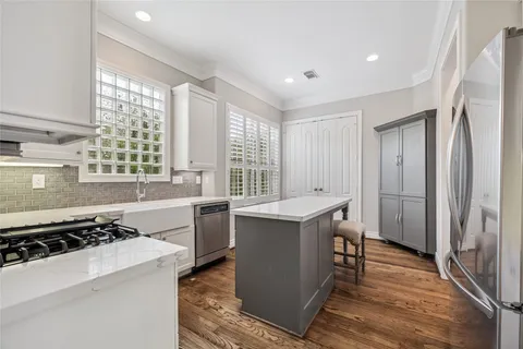 a kitchen with a stove a sink and a refrigerator