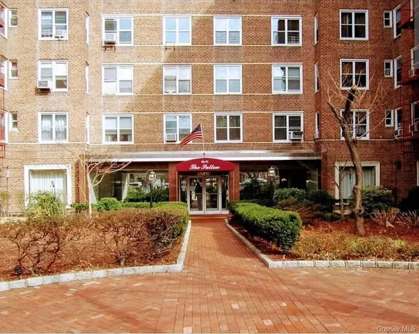 a front view of a building with plants