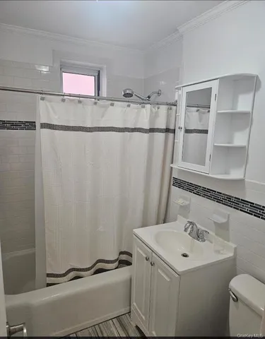 a bathroom with a sink and mirror with toilet