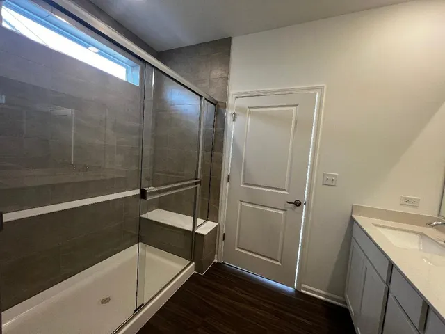 a bathroom with a shower and a sink