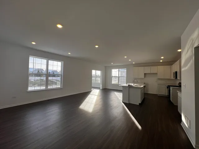 a view of a room with wooden floor and a window