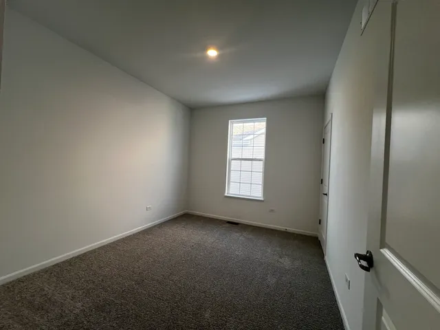 an empty room with a empty space and windows