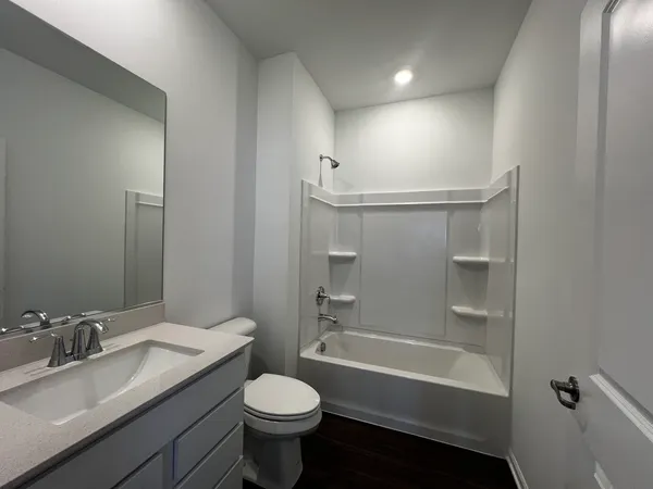 a bathroom with a sink toilet a mirror and shower