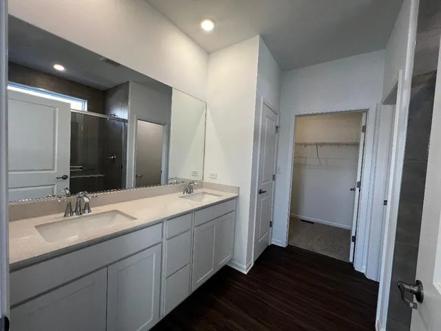 a bathroom with a double vanity sink and mirror