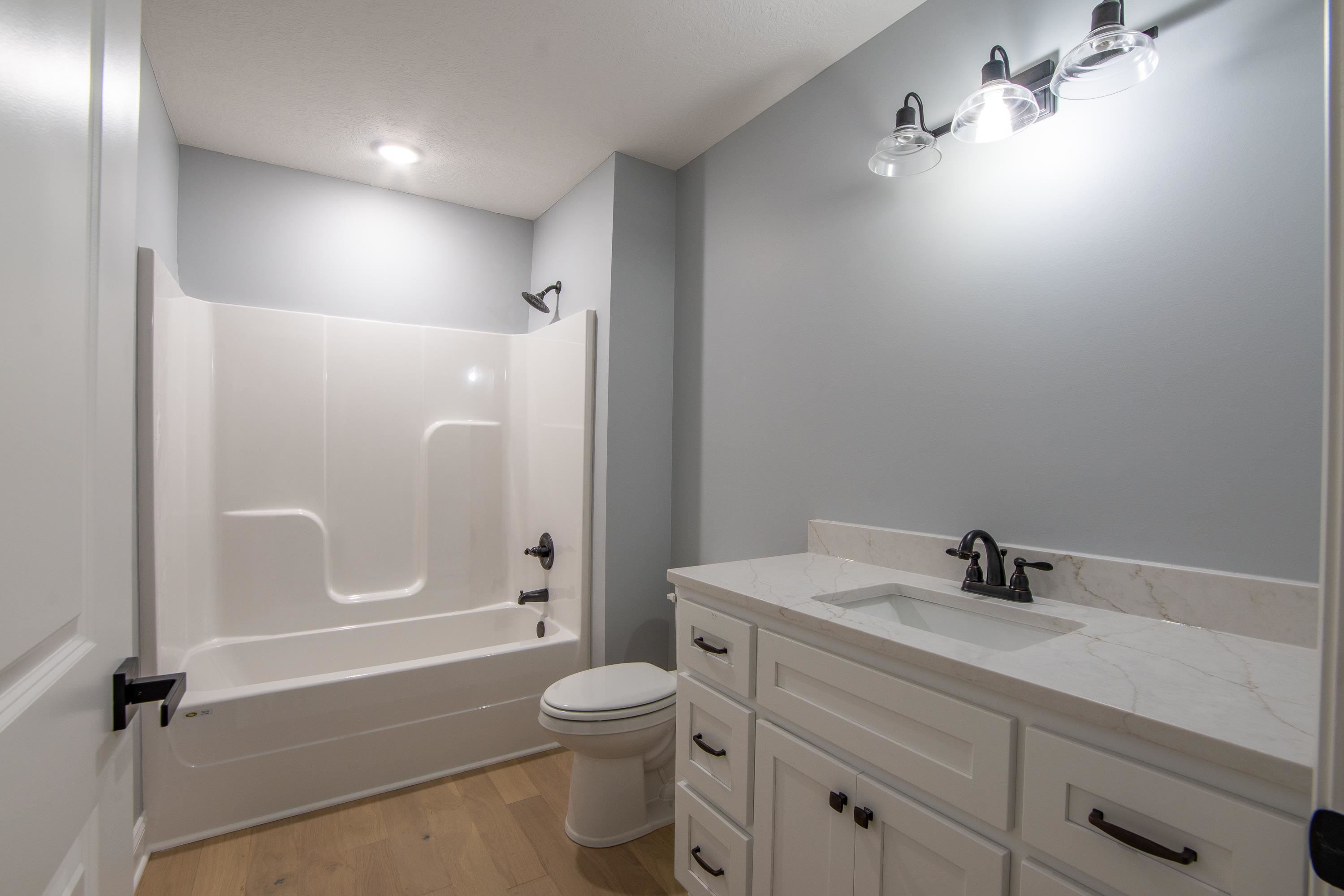 260 Range Road Savannah, TN 38372 - Photo 17 of 40 a bathroom with a sink a toilet and shower