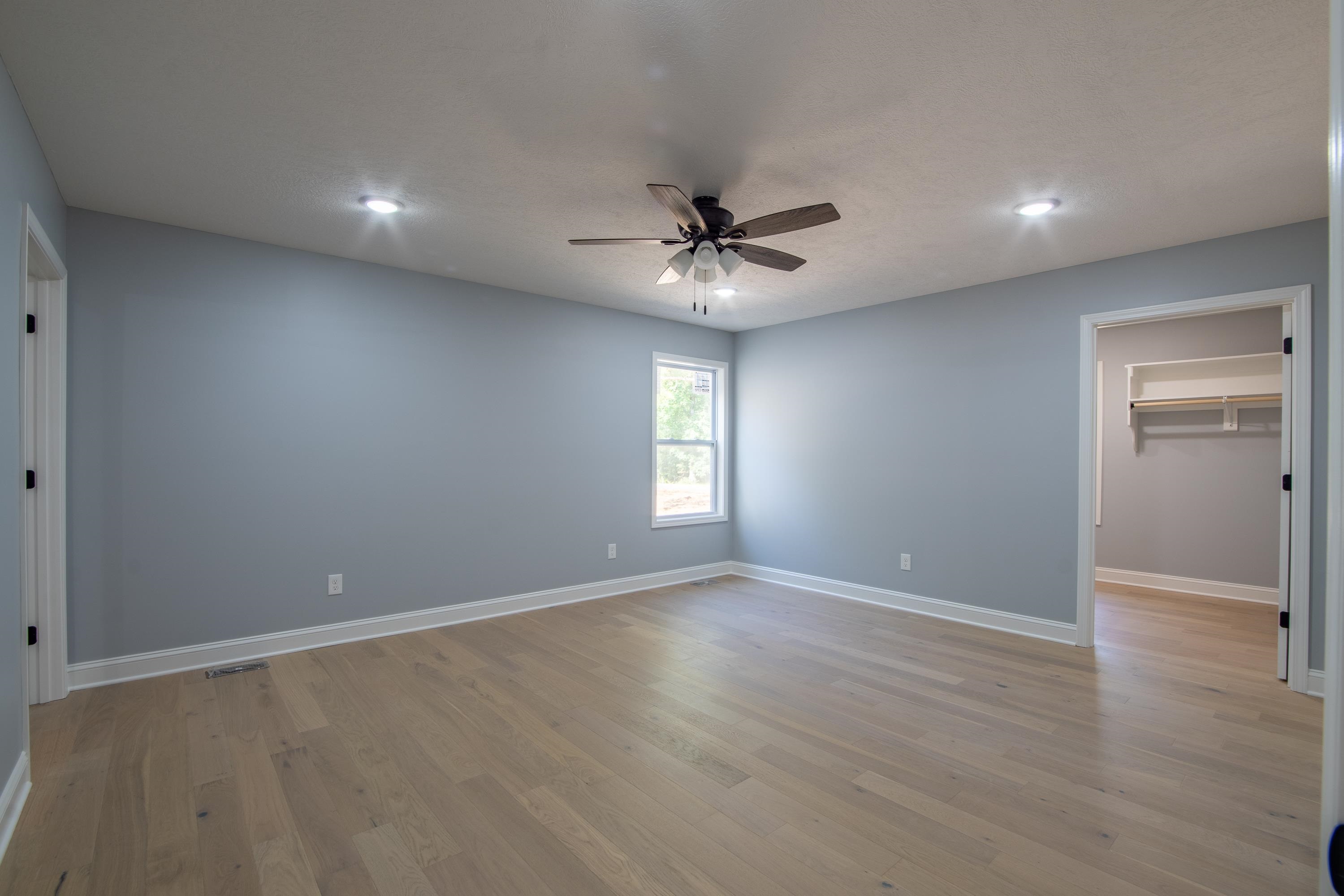 260 Range Road Savannah, TN 38372 - Photo 21 of 40 wooden floor in an empty room with a window