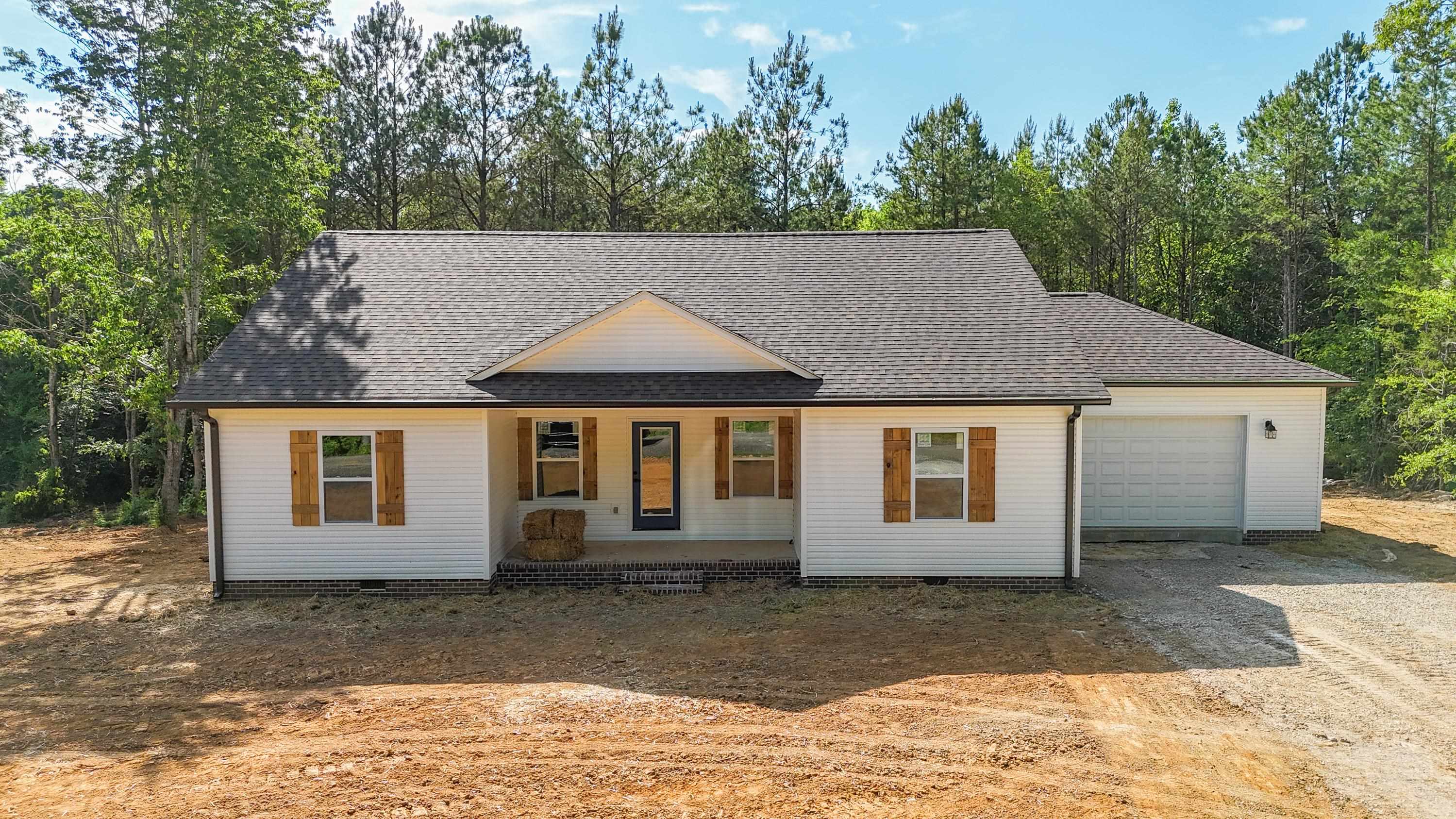 260 Range Road Savannah, TN 38372 - Photo 30 of 40 a view of a house with a yard plants and large tree