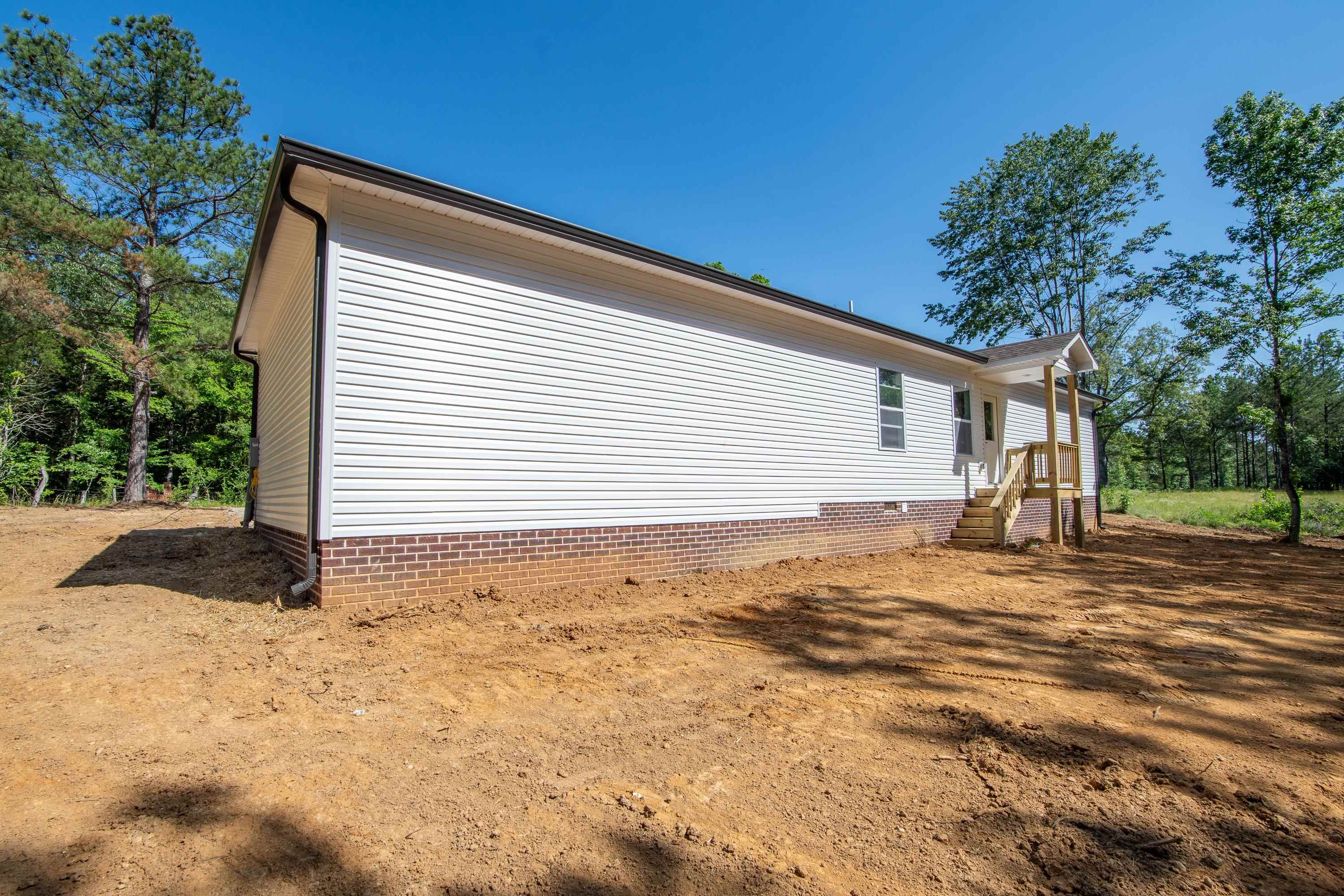 260 Range Road Savannah, TN 38372 - Photo 32 of 40 a view of a house with a yard