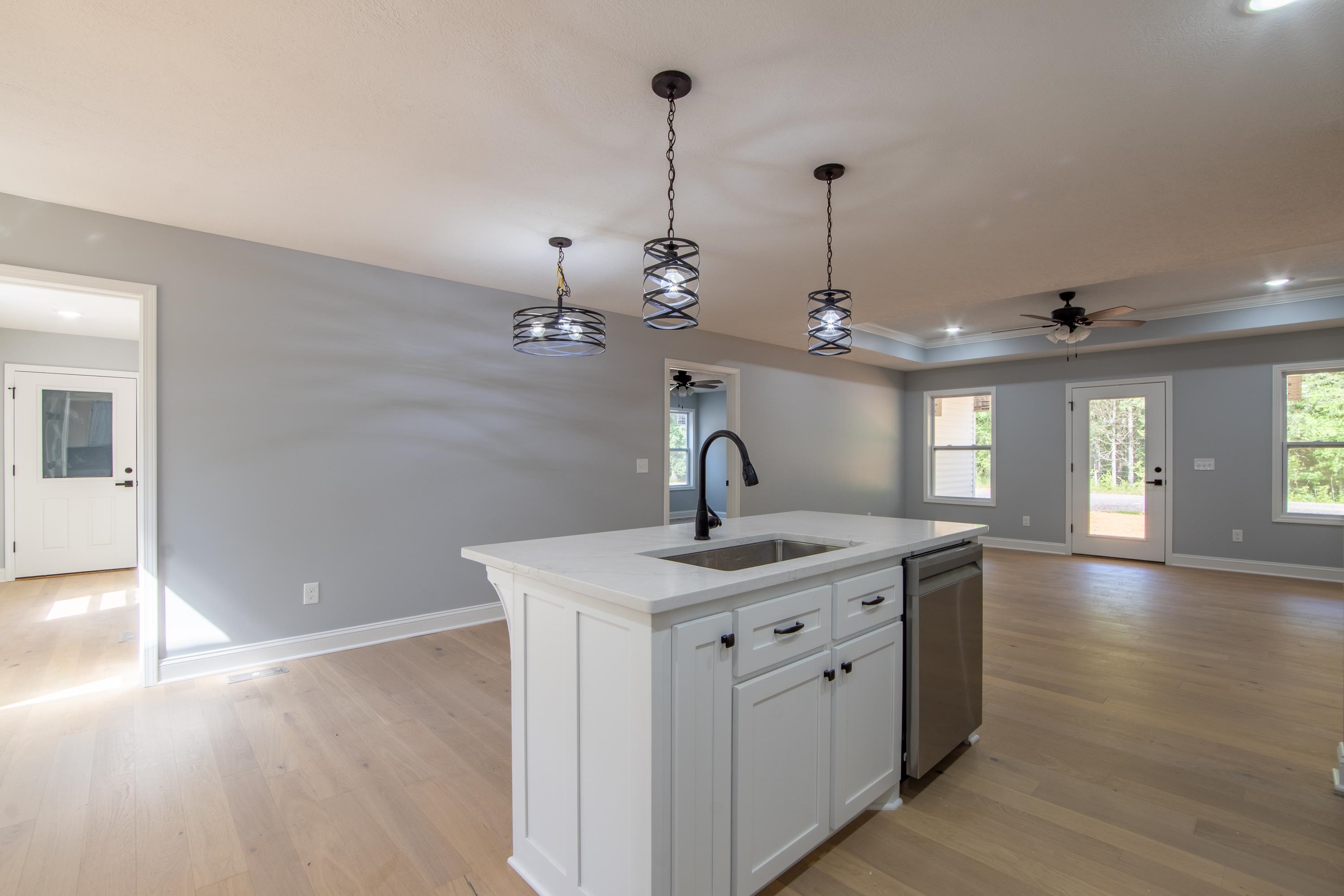 260 Range Road Savannah, TN 38372 - Photo 6 of 40 a kitchen with a sink and chandelier