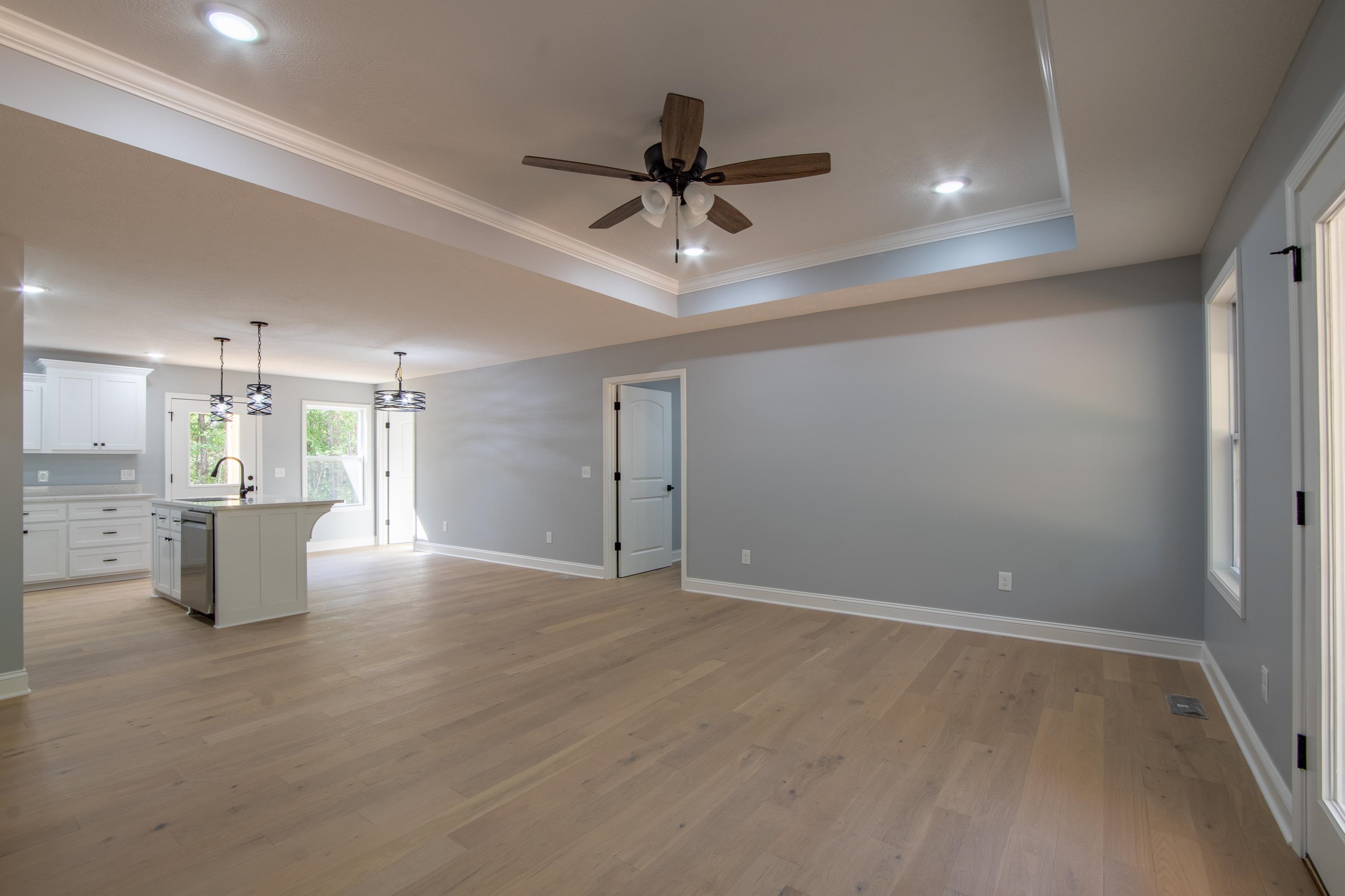 260 Range Road Savannah, TN 38372 - Photo 8 of 40 a view of an empty room and kitchen view with wooden floor