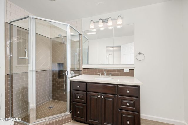 a bathroom with a sink double vanity and a shower
