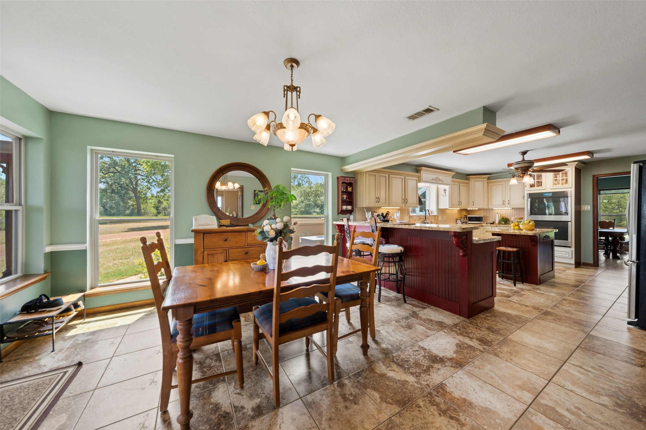 25948 Nelson Road Hempstead, TX 77445 - Photo 16 of 46 Additional breakfast and kitchen view showcasing the spacious dining area, hardwood flooring, and easy flow between the main living spaces.
