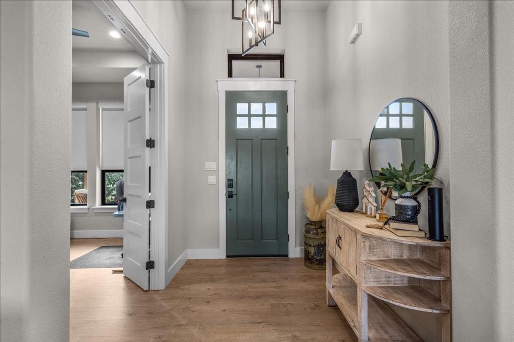 1059 Sweeney Way Weatherford, TX 76087 - Photo 6 of 37 Entryway featuring a paneled wood door and decorative lighting
