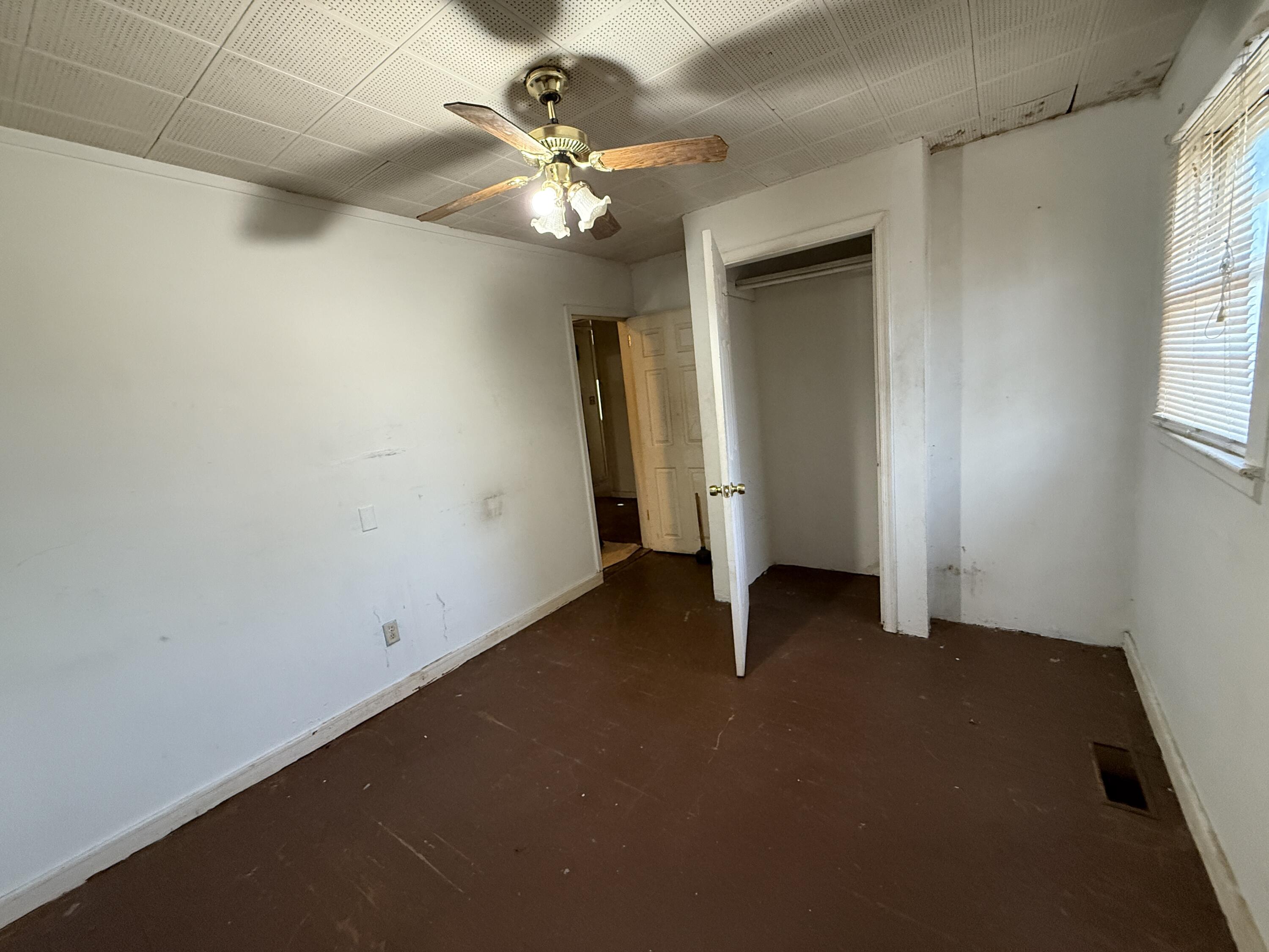 7212 Wood Haven Road Roanoke, VA 24019 - Photo 21 of 39 an empty room with a chandelier fan and windows