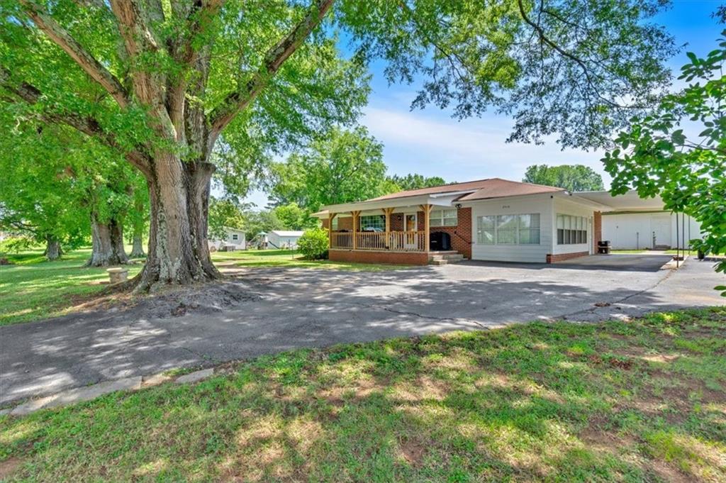 2454 Hall Station Road Northwest Adairsville, GA 30103 - Photo 12 of 35 a front view of a house with a garden