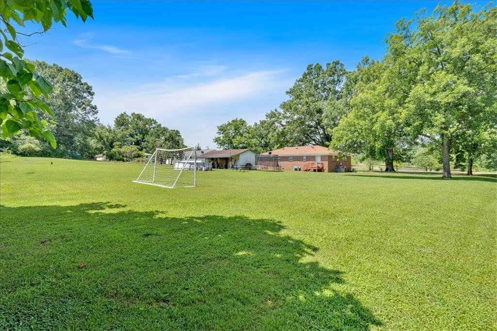 2454 Hall Station Road Northwest Adairsville, GA 30103 - Photo 16 of 35 a view of a grassy field with an trees