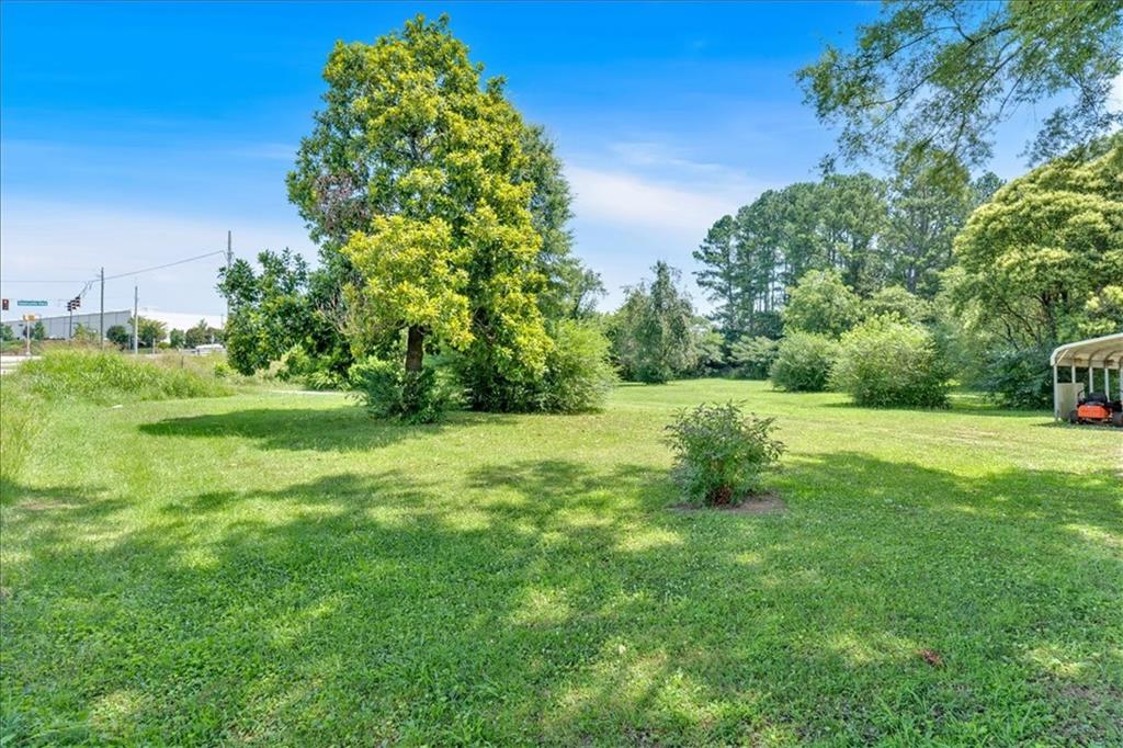 2454 Hall Station Road Northwest Adairsville, GA 30103 - Photo 2 of 35 a view of a grassy field with trees