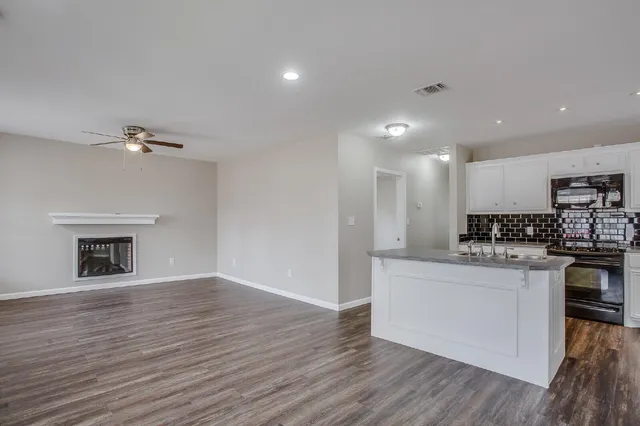 a kitchen with stainless steel appliances a white stove top oven and a fireplace