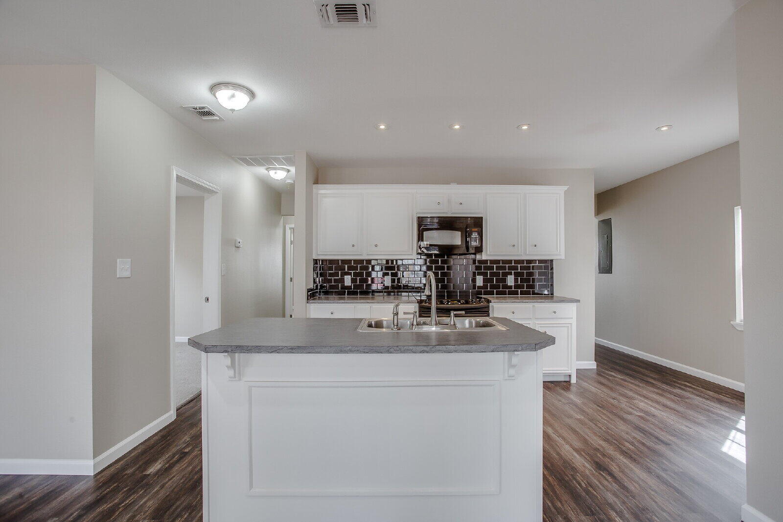 1909 16th Street, Unit FRONT Lubbock, TX 79401 - Photo 5 of 13 a kitchen with stainless steel appliances granite countertop a sink a stove and a refrigerator