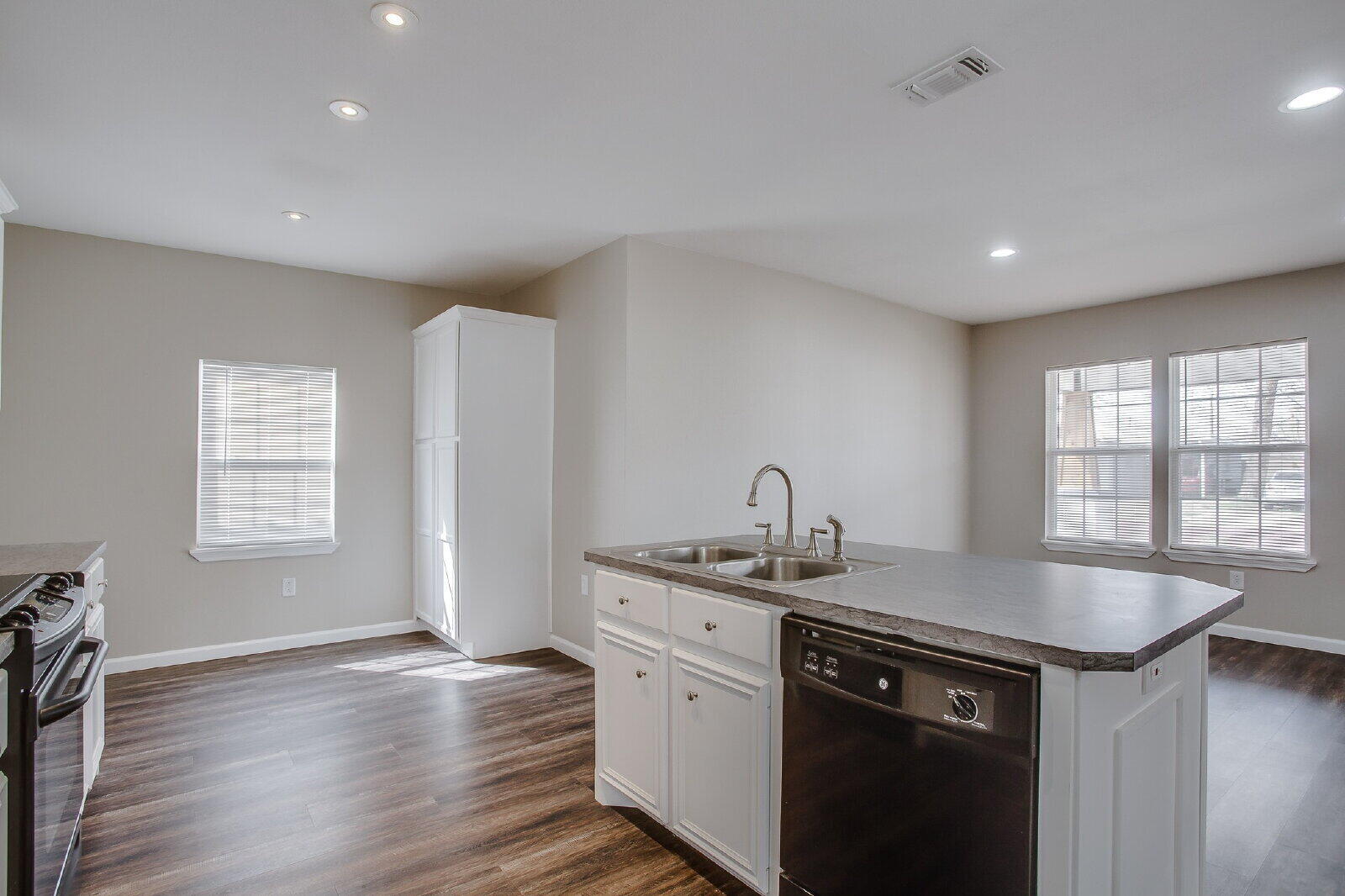 1909 16th Street, Unit FRONT Lubbock, TX 79401 - Photo 7 of 13 a kitchen with a sink cabinets and wooden floor