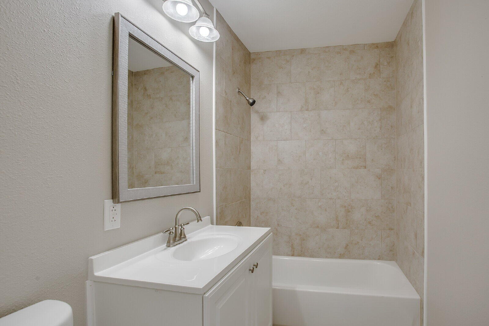 1909 16th Street, Unit FRONT Lubbock, TX 79401 - Photo 9 of 13 a bathroom with a sink a toilet and shower