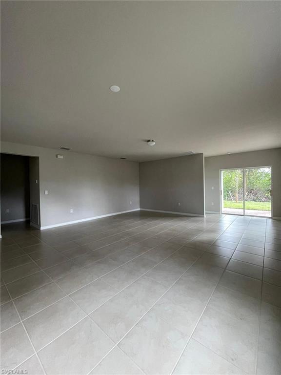 2802 40th Street Southwest Lehigh Acres, FL 33976 - Photo 12 of 14 Tiled empty room with baseboards