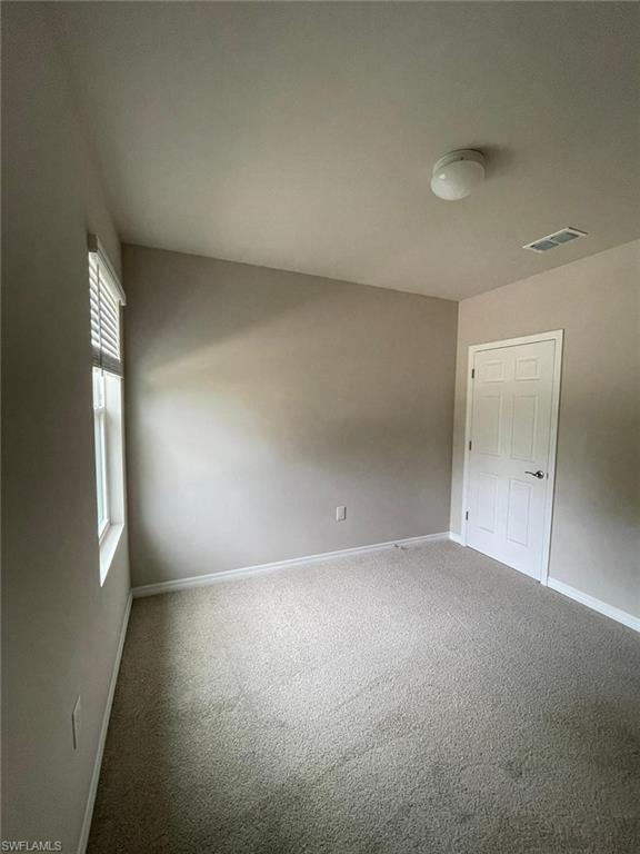 2802 40th Street Southwest Lehigh Acres, FL 33976 - Photo 7 of 14 Spare room with carpet flooring