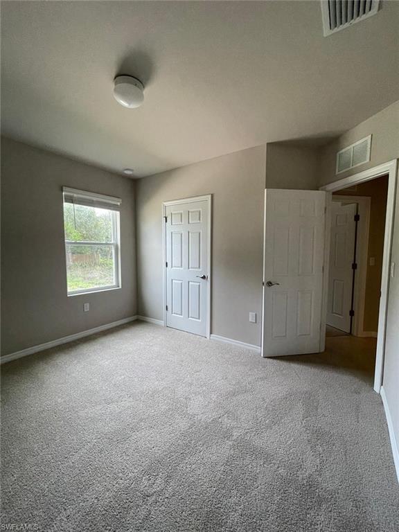 2802 40th Street Southwest Lehigh Acres, FL 33976 - Photo 8 of 14 Unfurnished bedroom with carpet and baseboards