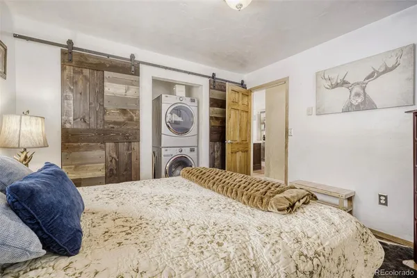 a bedroom with a bed and a mirror