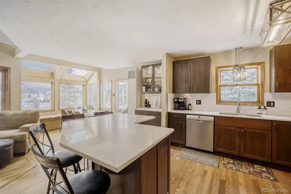 a large kitchen with kitchen island a large window