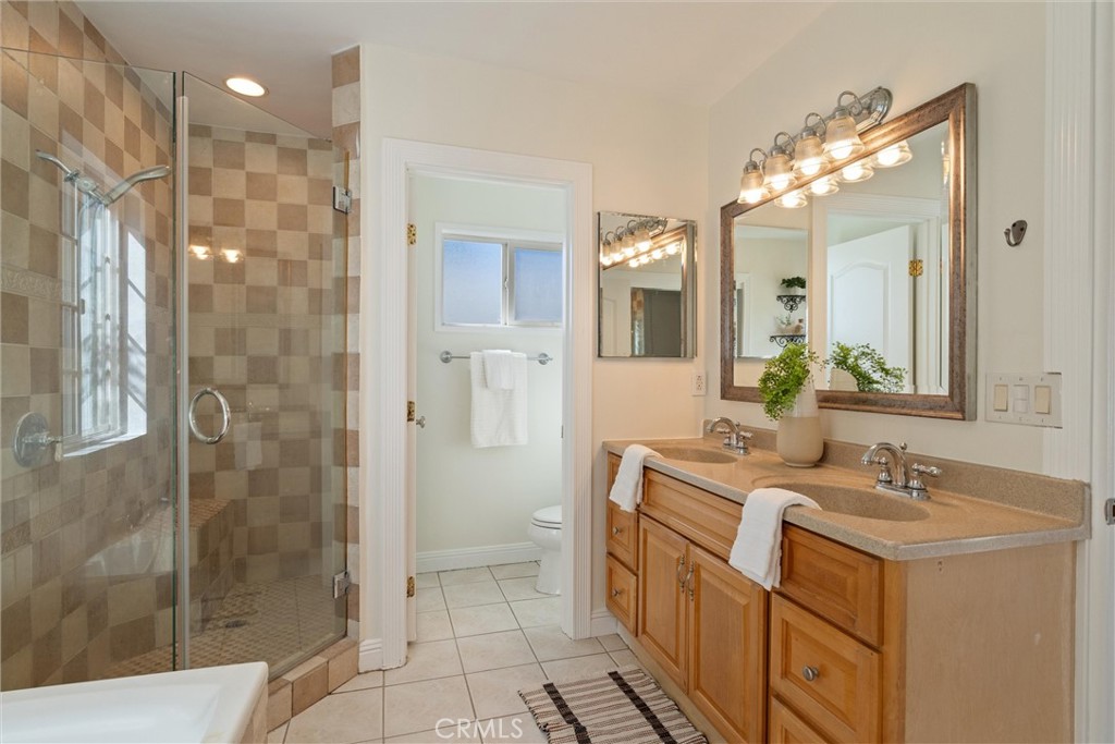 3426 Roxanne Avenue Long Beach, CA 90808 - Photo 12 of 21 a bathroom with a double vanity sink mirror and shower