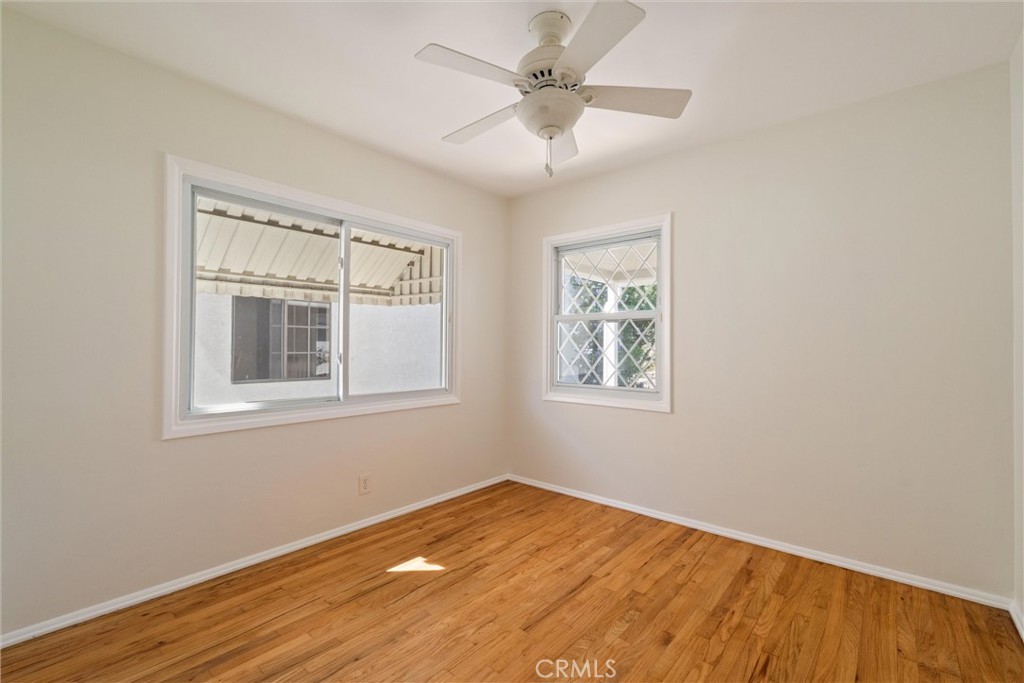 3426 Roxanne Avenue Long Beach, CA 90808 - Photo 14 of 21 a view of an empty room with wooden floor and a window